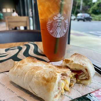 Starbucks - Bacon, Sausage & Egg Wrap with Iced Black Tea - Coffee & Tea Near Me - Jacksonville, Alabama Starbucks - Bacon, Sausage & Egg Wrap with Iced Black Tea - Coffee & Tea Near Me - Jacksonville, Alabama