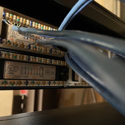 Personalized Computer Solutions - Behind a Wall Mounted Patch Panel with Hinge.