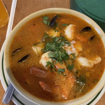 El Mariachi - Caldo de Cameron. Wow, that was good. - A bowl of seafood caldo de Cameron featuring shrimp, mussels, and chopped cilantro, served in a restaurant setting. - Mexican Near Me - Hazleton, Pennsylvania