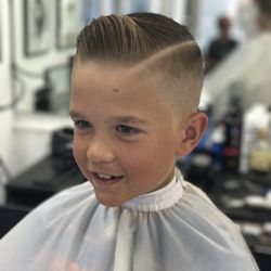 Modern Classics Barbershop - Bald fade with a side part. Styled with Suavecito pomade.