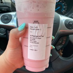 a pink drink in a plastic cup