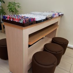 Rio Nails & Spa - Drying area...cute stools and a nice array of nail polishes.