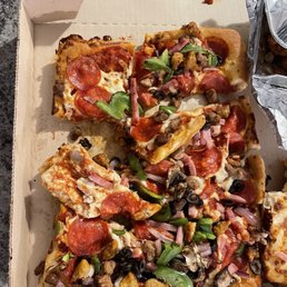 a box of pizza with a variety of toppings