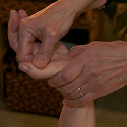 Wellness Studio Sarasota - Margo doing hand reflexology to improve health.