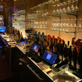 Mele Bistro - a bar with a lot of bottles and glasses - French Near Me - Arlington, Virginia Mele Bistro - a bar with a lot of bottles and glasses - French Near Me - Arlington, Virginia