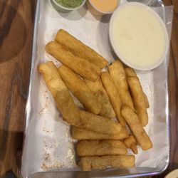 Tacos n Beer - Yuca fries with queso, guac, and chipotle sauce.