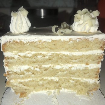 The Pantry KC - White cake topped with macarons - Desserts Near Me - Lenexa, Kansas The Pantry KC - White cake topped with macarons - Desserts Near Me - Lenexa, Kansas