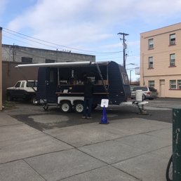 a coffee truck parked in a parking lot a coffee truck parked in a parking lot