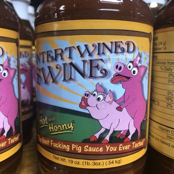 Hermann Wurst Haus - A jar of pig-themed sauce called "Intertwined Wines" features cartoon pigs on the label, with a humorous description and weight details. - Meat Shops Near Me - Hermann, Missouri