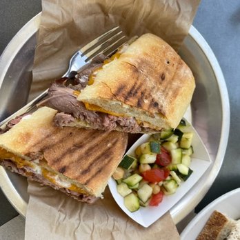 Aioli - Perfectly Grilled Steak Sandwich with Carmelized Onions, Cheddar and Soft on the inside firm on the outside fresh baguette. - Cafes Near Me - West Palm Beach, Florida