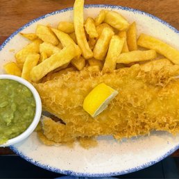 This is my plate of fish and chips with a side of mushy peas. You've got to try it cause it's delicious. This is my plate of fish and chips with a side of mushy peas. You've got to try it cause it's delicious.