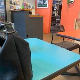 a black purse on a blue table a black purse on a blue table