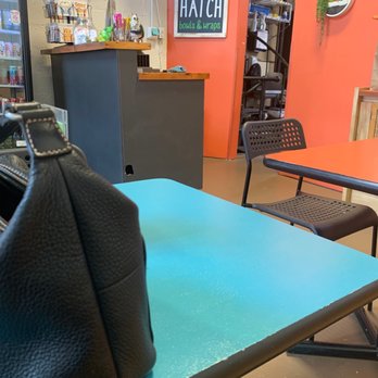 The Hungry Hatch - a black purse on a blue table - Food Trucks Near Me - Kansas City, Missouri The Hungry Hatch - a black purse on a blue table - Food Trucks Near Me - Kansas City, Missouri