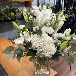 Coady Florist - Lilies, Hydrangea, Lisianthus, Snapdragons. All-white flower arrangement.