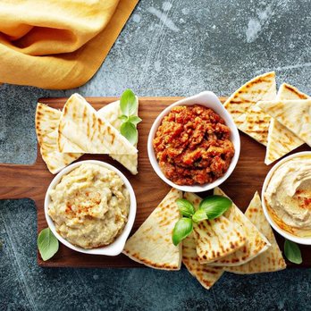 Ottoman Grill & Lounge - a platter of pita chips and dip - Food Delivery Services Near Me Ottoman Grill & Lounge - a platter of pita chips and dip - Food Delivery Services Near Me