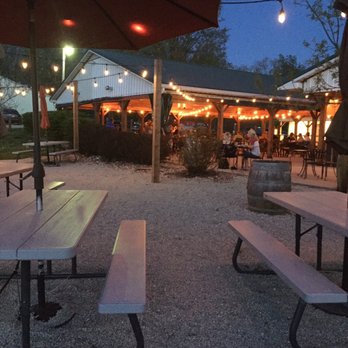 Belmont Vineyards - a patio with tables and umbrellas - Wineries Near Me - Leaburg, Missouri