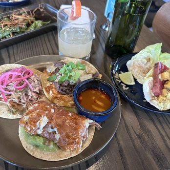 Teocalli Cocina - 4 tacos. Clockwise from the left. Pork Carnitas, carne asada and Birra taco. On the right plate is the big eye tuna. - Mexican Near Me - Arvada, Colorado