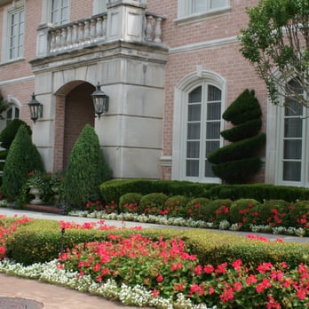 Palm Gardens - the front of a large brick house - Landscaping Near Me - Dallas, Texas Palm Gardens - the front of a large brick house - Landscaping Near Me - Dallas, Texas