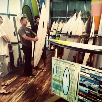 Golden Flooring - two men holding surfboards in a surf shop - Flooring Near Me - Ventura, California Golden Flooring - two men holding surfboards in a surf shop - Flooring Near Me - Ventura, California