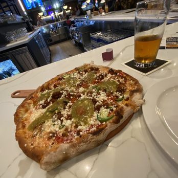 Crust Brewing - South of the Border pizza: Chorizo, jalapeno, blistered tomato, red onion, salsa verde, and queso fresco. - Breweries Near Me - Rosemont, Illinois Crust Brewing - South of the Border pizza: Chorizo, jalapeno, blistered tomato, red onion, salsa verde, and queso fresco. - Breweries Near Me - Rosemont, Illinois