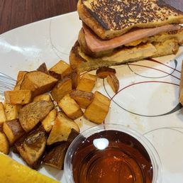1/2 a Monte Cristo and potatoes with syrup and lemon slice. 1/2 a Monte Cristo and potatoes with syrup and lemon slice.