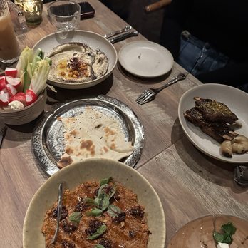 Delbar Middle Eastern - Muhamara (front), hummus (back), lamb ribs (right) - Persian/Iranian Near Me - Atlanta, Georgia Delbar Middle Eastern - Muhamara (front), hummus (back), lamb ribs (right) - Persian/Iranian Near Me - Atlanta, Georgia