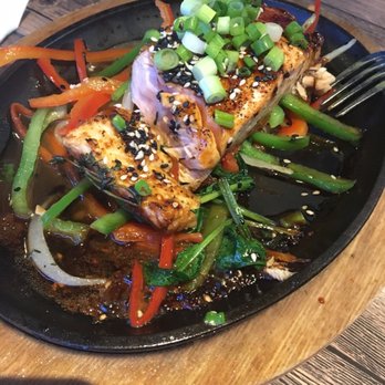 Travesias - Sizzling Salmon- very good (mom couldn't help herself and took a bite bf the pic lol) - Latin American Near Me - Bronx, New York Travesias - Sizzling Salmon- very good (mom couldn't help herself and took a bite bf the pic lol) - Latin American Near Me - Bronx, New York