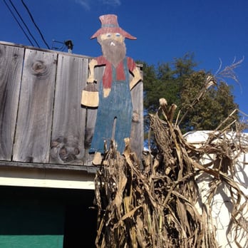 Podunk Produce - a scarecrow standing on top of a pile of dried corn - Fruits & Veggies Near Me - Mineral Bluff, Georgia Podunk Produce - a scarecrow standing on top of a pile of dried corn - Fruits & Veggies Near Me - Mineral Bluff, Georgia
