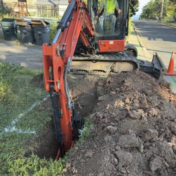 ImOn Communications - Backhoe digging a hole near the corner of our property. ImOn claimed they were within the city easement.