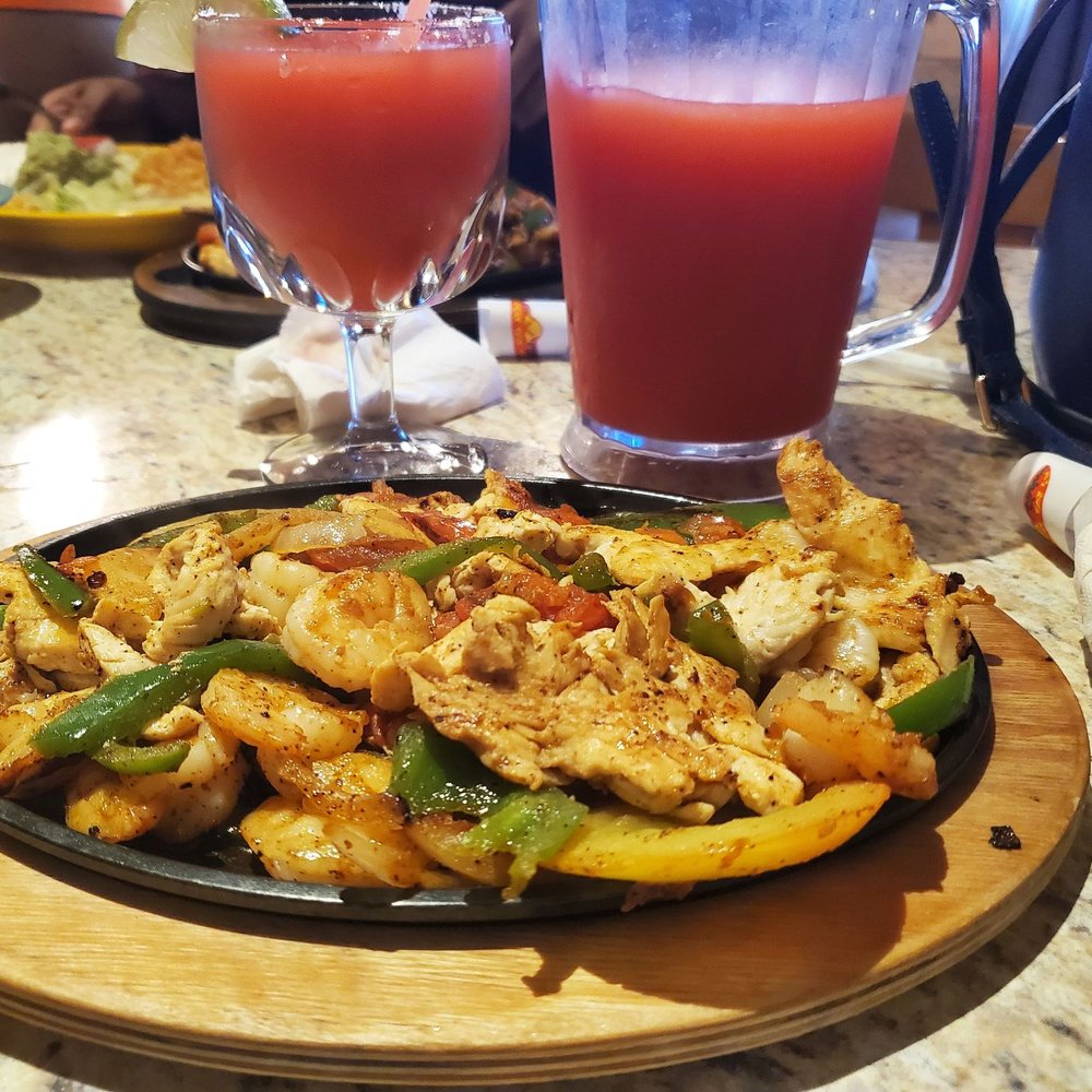 a plate of food and a glass of juice a plate of food and a glass of juice
