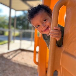 Northwoods Early Learning Center Preschool - Peek-a-boo!  Fresh air and a climber make for loads of fun!