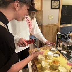 Diana's Private Kitchen - Chef Diana helping show how to toast the crème brûlée