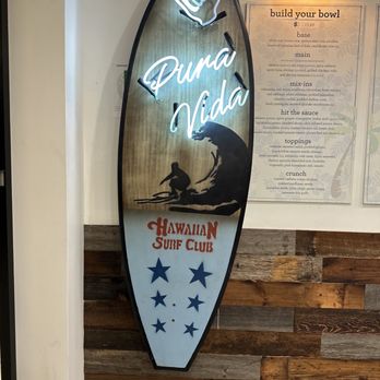 Hokey Poké - a surfboard with a neon sign on it - Poke Near Me - New York, New York Hokey Poké - a surfboard with a neon sign on it - Poke Near Me - New York, New York