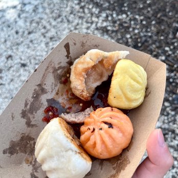 Mao’s Bao - a person's hand holding a piece of food - Shanghainese Near Me - New York, New York Mao’s Bao - a person's hand holding a piece of food - Shanghainese Near Me - New York, New York