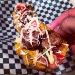 Mobile Munchiez - Open faced Jibarito - Tostones topped with Italian sausage, aioli, sour cream, fresh tomatoes, cheese, and chives.