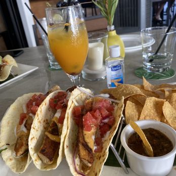 Tommy Bahama - Fish tacos with salsa and chips. Drink is called "Blue my mind." - Seafood Near Me - Plano, Texas Tommy Bahama - Fish tacos with salsa and chips. Drink is called "Blue my mind." - Seafood Near Me - Plano, Texas