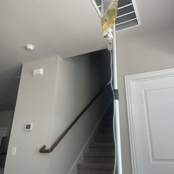 Smooth Aesthetics - An IV drip is attached to a stand positioned next to a staircase in a home interior, with a ceiling vent visible. - Medical Spas Near Me