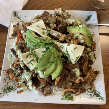 Arepitas - Chicken and what appeared to be flank steak with sautéed onions and peppers on a bed of white rice; drizzled with an avocado sauce. - Venezuelan Near Me - Harker Heights, Texas