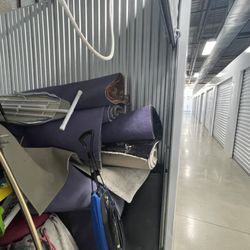 Two Men and a Truck Troy - Furniture and rugs thrown into storage unit.
