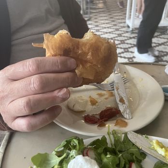 Tatte Bakery & Cafe | Harvard Square - A bite into the chocolate croissant. - Coffee & Tea Near Me - Cambridge, Massachusetts