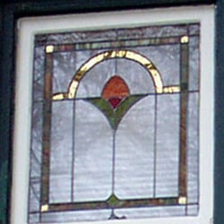Double-sided gold mirror in a Chicago Bungalow window.