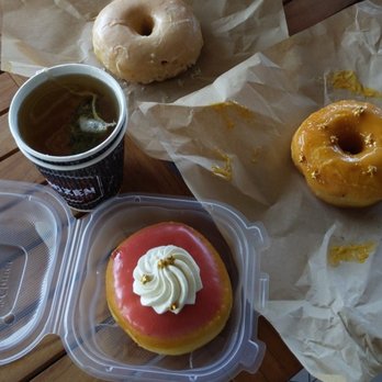 Devil's Dozen Donut Shop - Strawberry rhubarb (bottom), passion fruit (right), and vanilla bean (top) donuts with tea. - Donuts Near Me - San Diego, California Devil's Dozen Donut Shop - Strawberry rhubarb (bottom), passion fruit (right), and vanilla bean (top) donuts with tea. - Donuts Near Me - San Diego, California