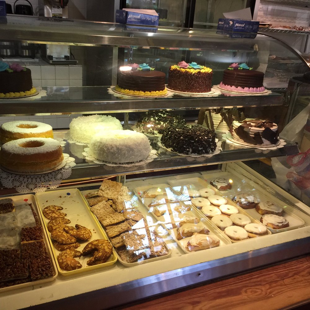 a display case full of cakes and pastries a display case full of cakes and pastries