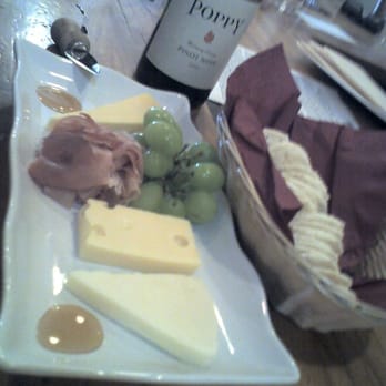 San Clemente Wine Company - Semisoft trio ($10), add prosciutto ($5.50), comes with grapes, dabs of honey, and a basket of crackers - Beer, Wine & Spirits Near Me - San Clemente, California