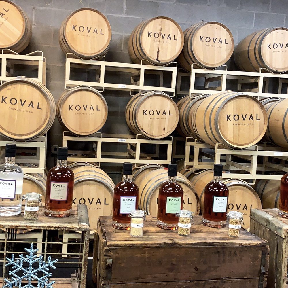 KOVAL Distillery - Bourbon Barrels and Koval's main liquor selection (with grains used in each in front of the bottles) - Distilleries Near Me - Chicago, Illinois KOVAL Distillery - Bourbon Barrels and Koval's main liquor selection (with grains used in each in front of the bottles) - Distilleries Near Me - Chicago, Illinois