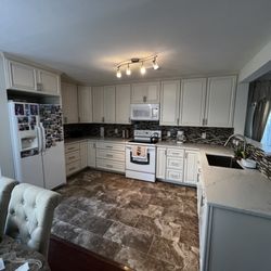 Palacios Construction Group - Kitchen remodel in Houston, TX - Custom cabinets, quartz countertops, mosaic backsplash, and modern lighting for a stylish upgrade.