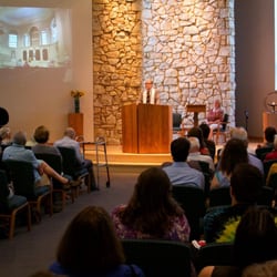 Rev. Tom leading Sunday service in DUUC's Sanctuary.