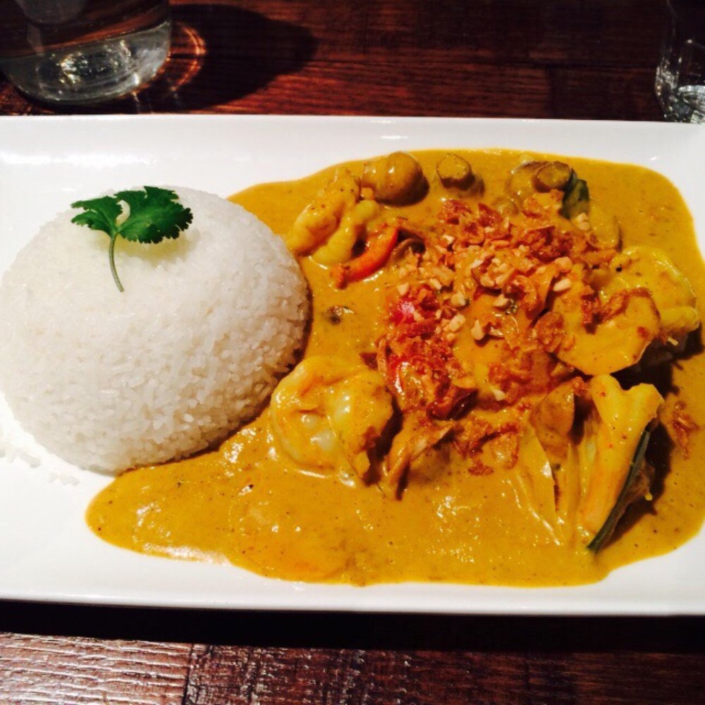 Broken rice with curry sauce topped with coriander leaves Broken rice with curry sauce topped with coriander leaves