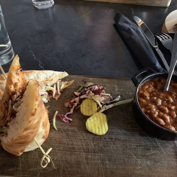 Maligne Canyon Wilderness Kitchen - Slow roasted beef brisket sandwich with a side of baked beans. - Canadian (New) Near Me - Jasper, Alberta Maligne Canyon Wilderness Kitchen - Slow roasted beef brisket sandwich with a side of baked beans. - Canadian (New) Near Me - Jasper, Alberta