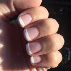 The horrible French I got done here. Not straight and smeared white paint in the middle of my nails. Not happy